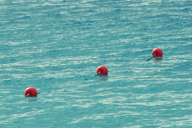 three red bouys by the blue sea - nobody inflatable equipment rope imagens e fotografias de stock