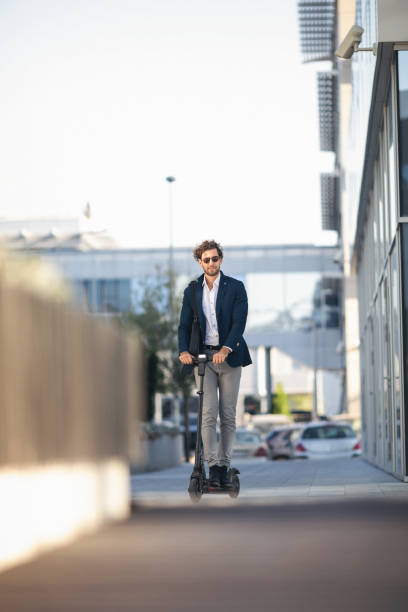 istock Businessman on e scooter in the city 1185854224