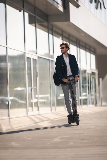 istock Businessman on e scooter in the city 1185854298