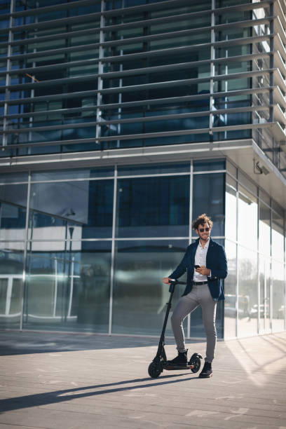 istock Businessman on e scooter in the city 1185854493