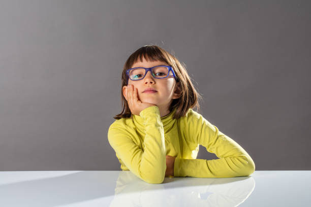 istock smiling smart girl holding her head enjoying thinking, looking adorable 1185854687