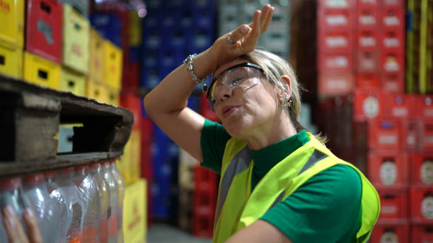 Exhausted employee at warehouse Exhausted employee at warehouse heat stress stock pictures, royalty-free photos & images