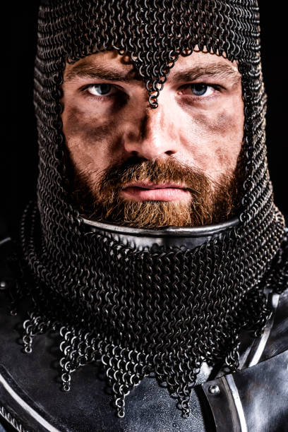 Headshot of mature man with chains around the head on gray background