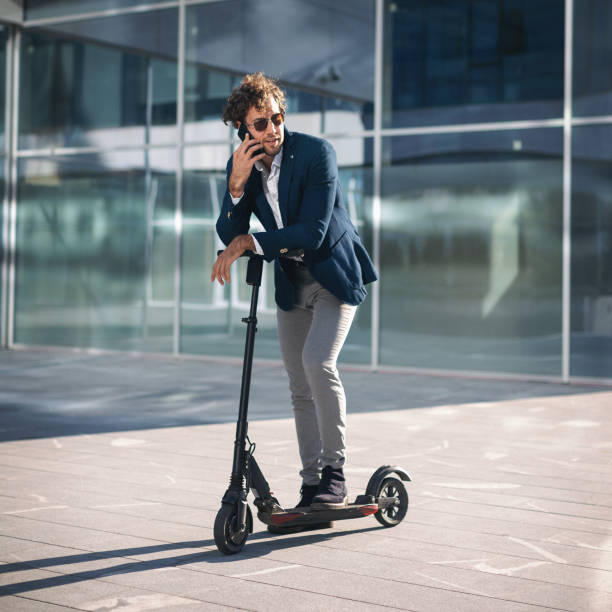 istock Businessman on e scooter in the city 1185856229