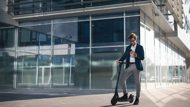 istock Businessman on e scooter in the city 1185856917
