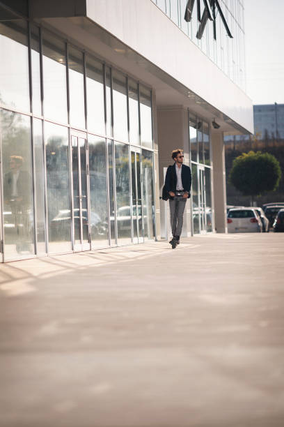 istock Businessman on e scooter in the city 1185857038