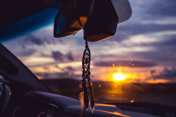 istock dream catcher on car over blurred highway background. 1185859100