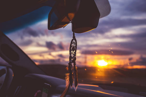 istock dream catcher on car over blurred highway background. 1185859110