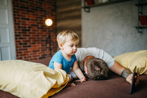 istock Father and son cuddling in bed 1185860502