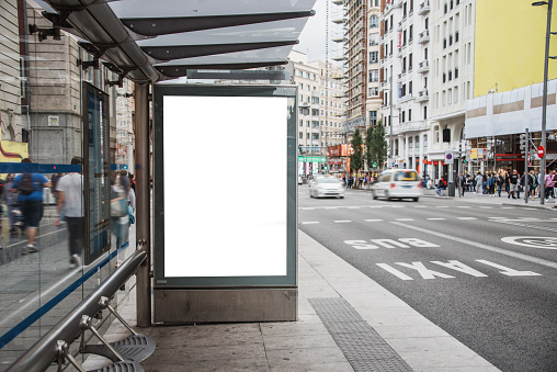 Blank advertisement panel on modern bus stop in Spain