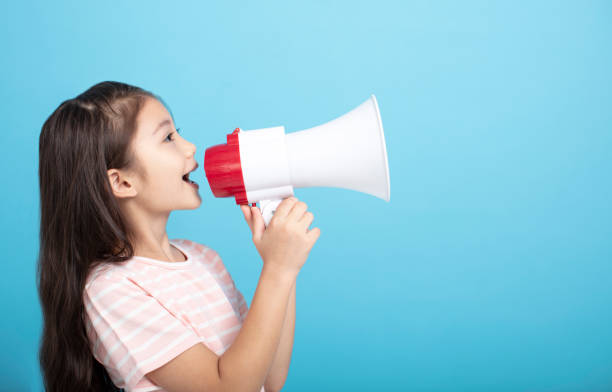 istock Little girl screaming and shouting with megaphone 1185861995