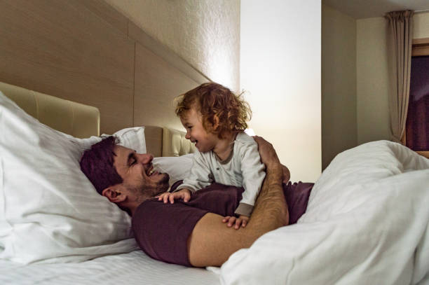 istock Happy family having fun on bed 1185862857