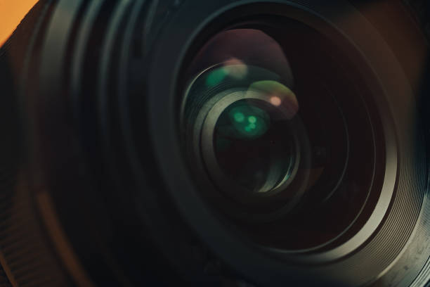 istock Close up beautiful black camera lens on a yellow background. Macro view.. 1185863142