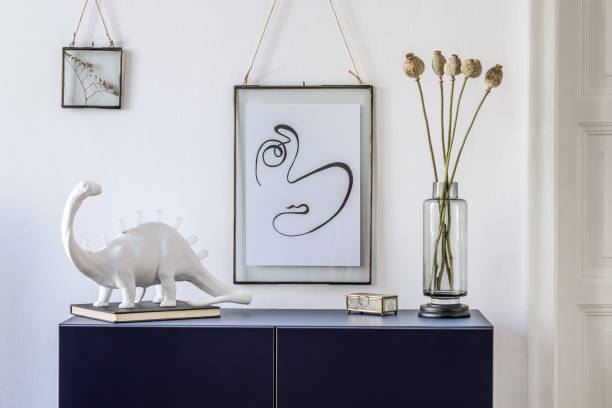 istock Stylish scandinavian living room with mock up poster frame, navy blue commode, table lamp and elegant accessories. Modern home decor. Interior design. Template Ready to use. 1185863155