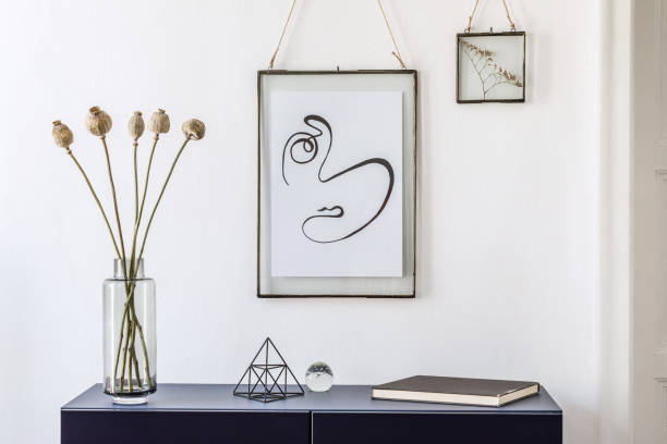 istock Stylish scandinavian living room with mock up poster frame, navy blue commode, table lamp and elegant accessories. Modern home decor. Interior design. Template Ready to use. 1185863218