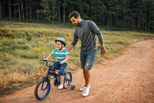 istock Father teaches son to ride a bike 1185864492