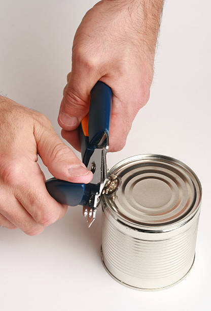 istock can opener and hands of man 118586477