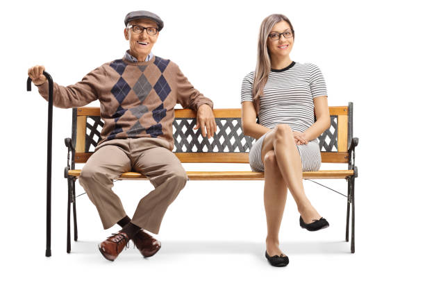 istock Elderly man and a young woman resting on a bench 1185864873