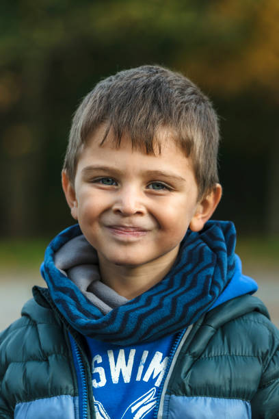 istock Cute blonde child looking at camera 1185866396
