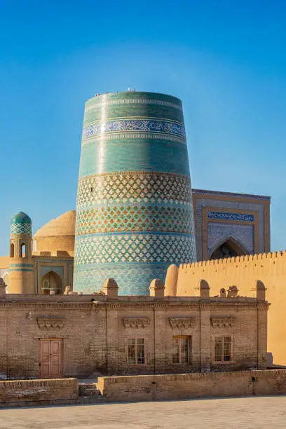 Famous Kalta Minor Minaret in Khiva, one of the most famous places at the historic silk road and one of the most important destinations for the caravans. Khiva is one of old cities of ancient Khorezm and was also known in the past as Kheeva, Khorasam, Khoresm, Khwarezm, Khwarizm, Khwarazm, Chorezm. It is is listed as UNESCO World Heritage Site and the town in Xorazm Region is one of the major tourist destinations in Uzbekistan and whole Central Asia.