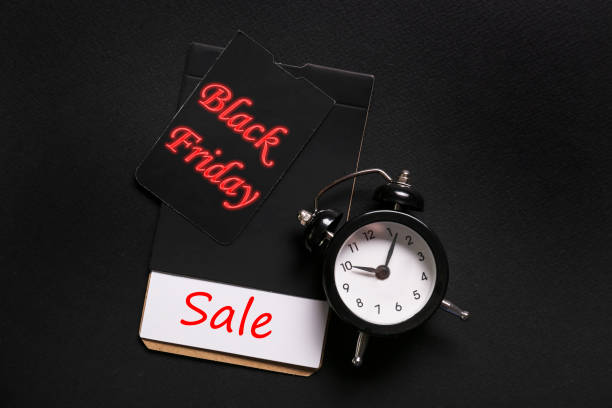 istock black friday themed concept with objects on black paper textured background. 1185867529