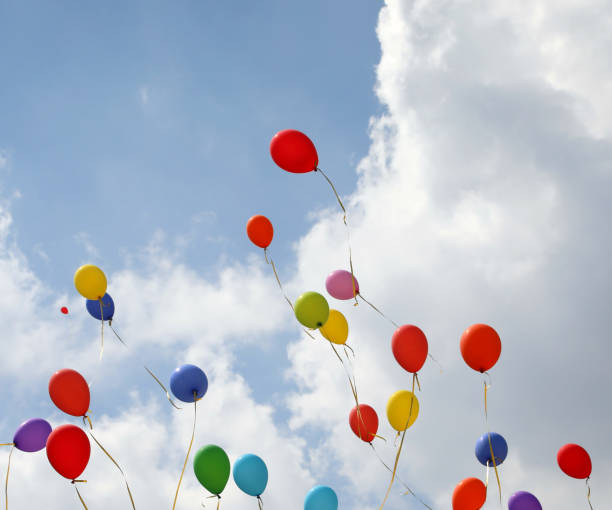 istock colored balloons on the blue sky with clouds 1185867811