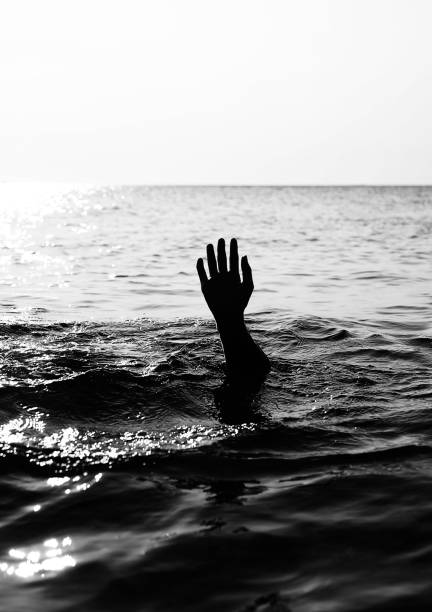 istock hand of man on the black ocean 1185867828