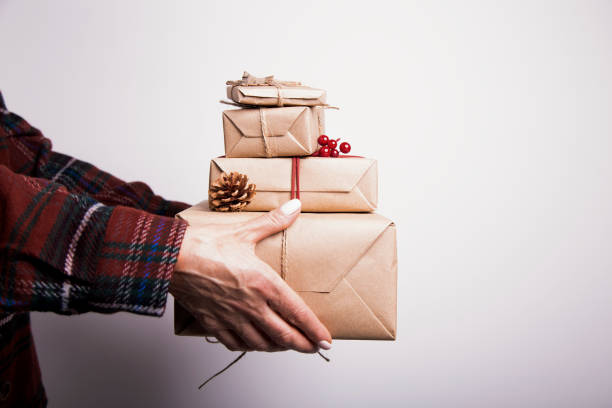 Female hands holding pile of gifts stock photo