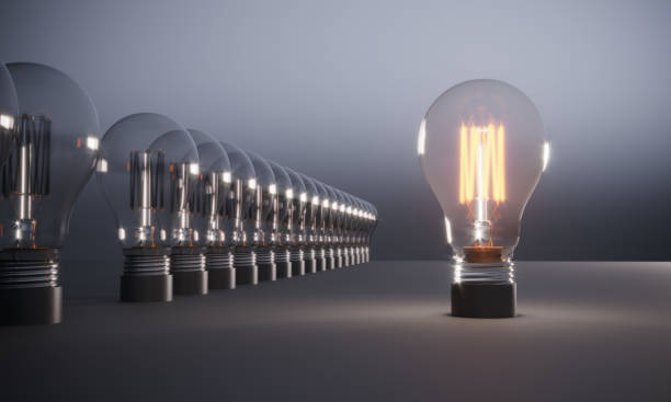 istock Glowing Light Bulb Standing Out From the Crowd 1185870573