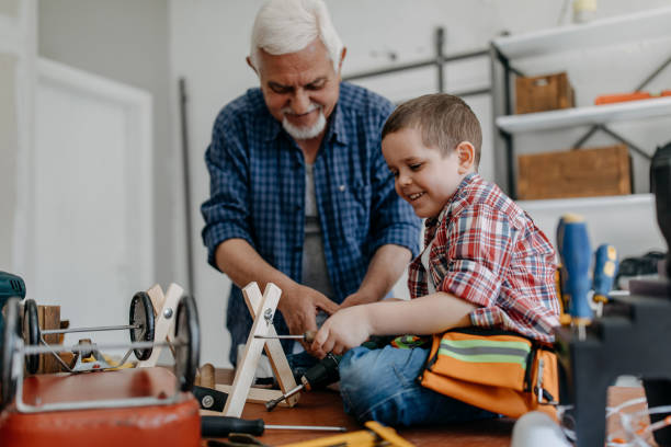 istock Grandfather and grandson building a ship 1185871066