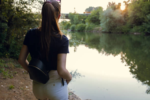 istock Young woman near the river 1185871277