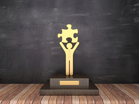 Trophy with Business Pictogram with Puzzle on Wood Floor - Chalkboard Background - 3D Rendering
