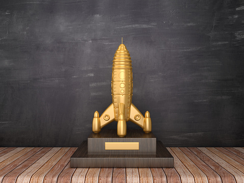 Trophy with Retro Rocket on Wood Floor - Chalkboard Background - 3D Rendering