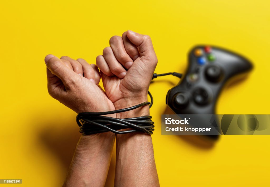 wired hands with joypad wired hands with joypad, video game addiction Addiction Stock Photo