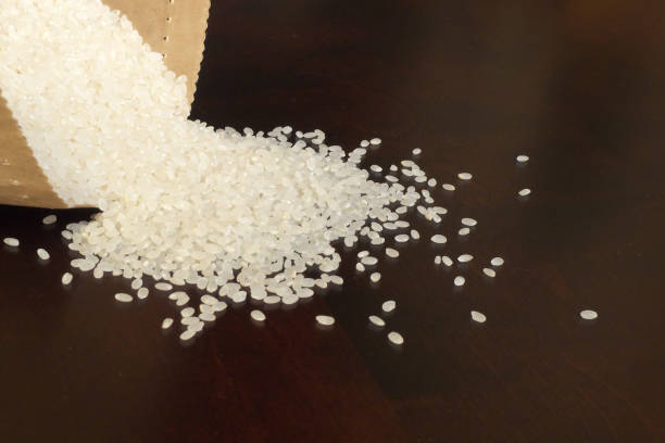 istock White rice on wood background 1185872947