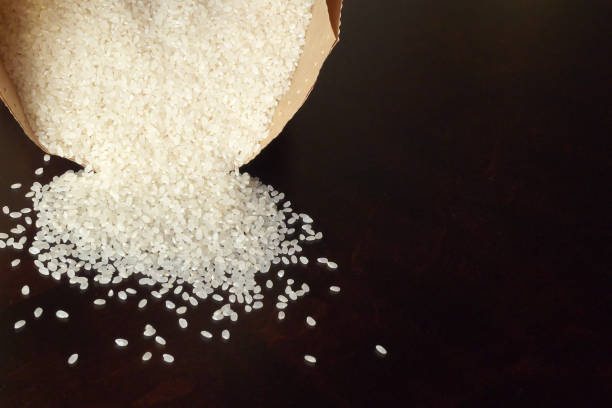 istock White rice on wood background 1185872953