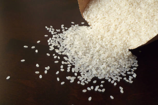 istock White rice on wood background 1185872957