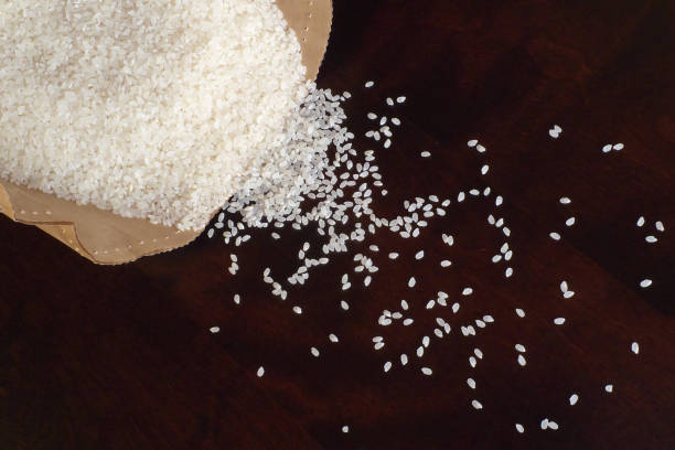 istock White rice on wood background 1185872963