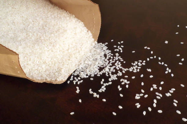 istock White rice on wood background 1185872966