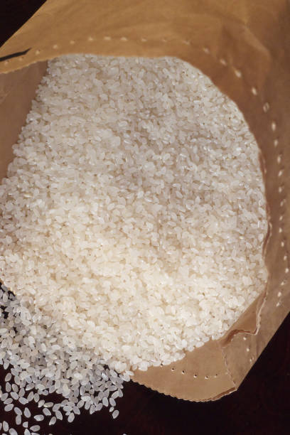 istock White rice on wood background 1185872983