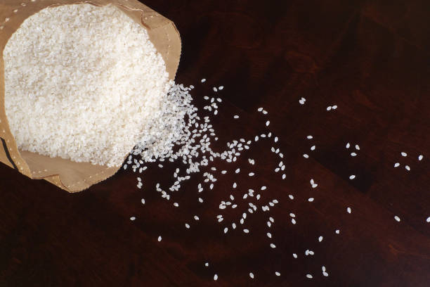 istock White rice on wood background 1185873022
