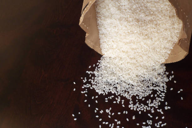 istock White rice on wood background 1185873025
