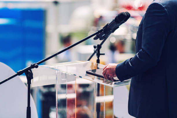 istock Midsection Of Man Holding Digital Tablet While Standing By Microphone 1185873050