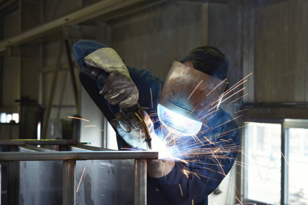 istock welder works in metal construction - construction and processing of steel components 1185873159
