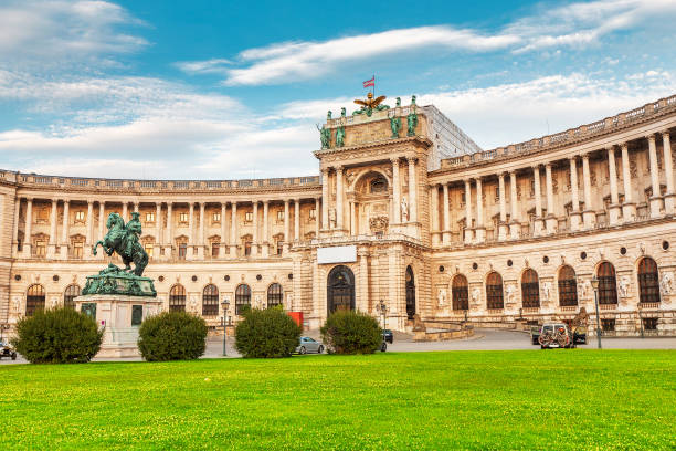 The Hofburg building view with green law in Vienna city, Austria 19 July 2019, Vienna, Austria: The Hofburg building view with green law in Vienna city, Austria heldenplatz stock pictures, royalty-free photos & images