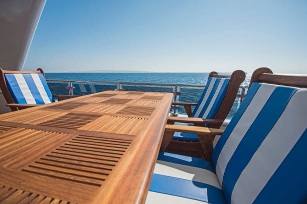 istock Table and chairs on deck of a luxury motor yacht 1185878140