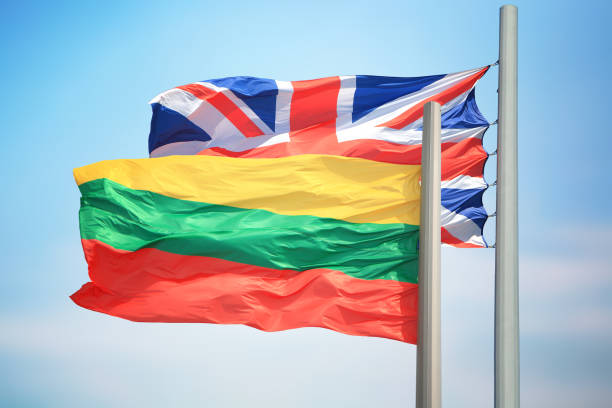 Lithuanian and British flags against the background of blue sky