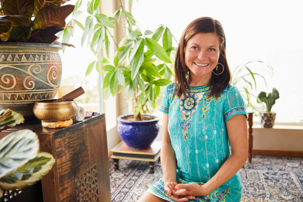 istock Young woman smiling while sitting in her alternative therapy studio 1185879603