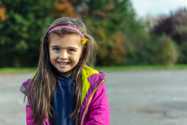 istock Cute blonde child looking at camera 1185880410