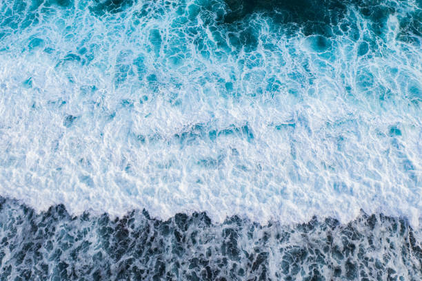 istock Big ocean waves hitting a coral rif. View from above. 1185884295